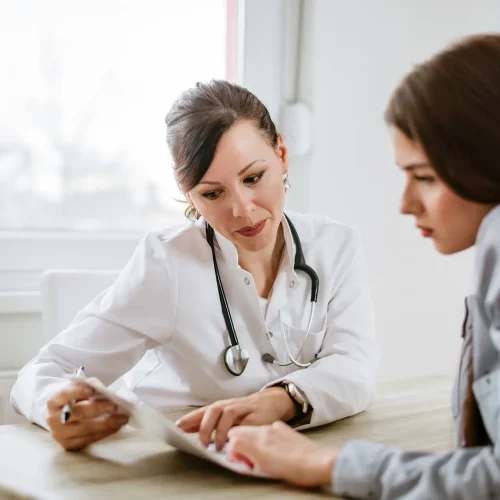 Charming female doctor giving advice to a female patient.